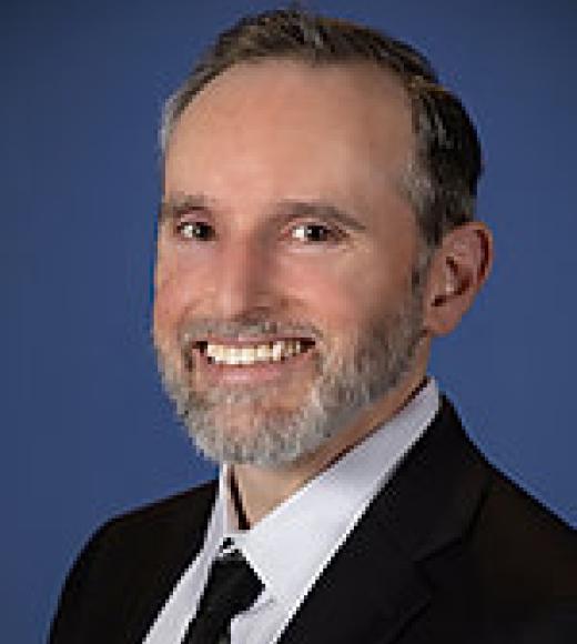 A professional headshot of Dr. Christopher Lucchesi.