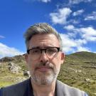 A picture of a spectacled man.